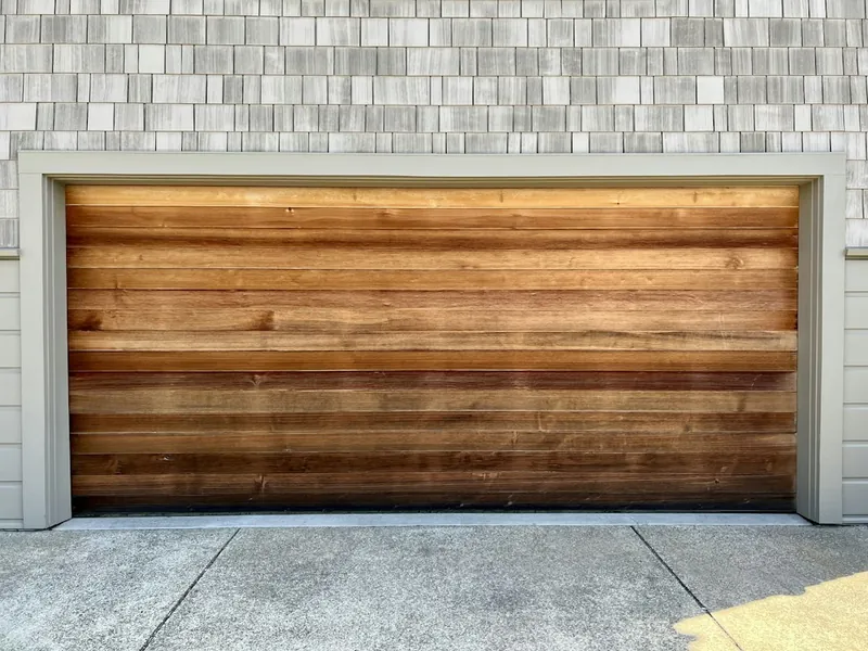 Newly installed natural wood plank garage door