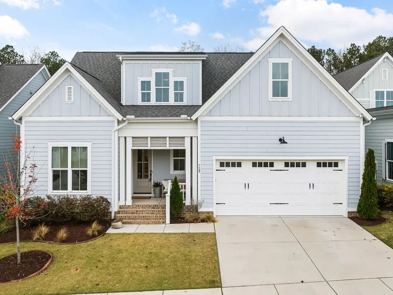 Two-story home with a white carriage-style garage door in El Cajon